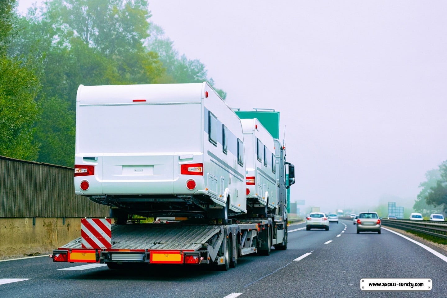 Minivans, transporter trucks, and automobile carriers on the road.