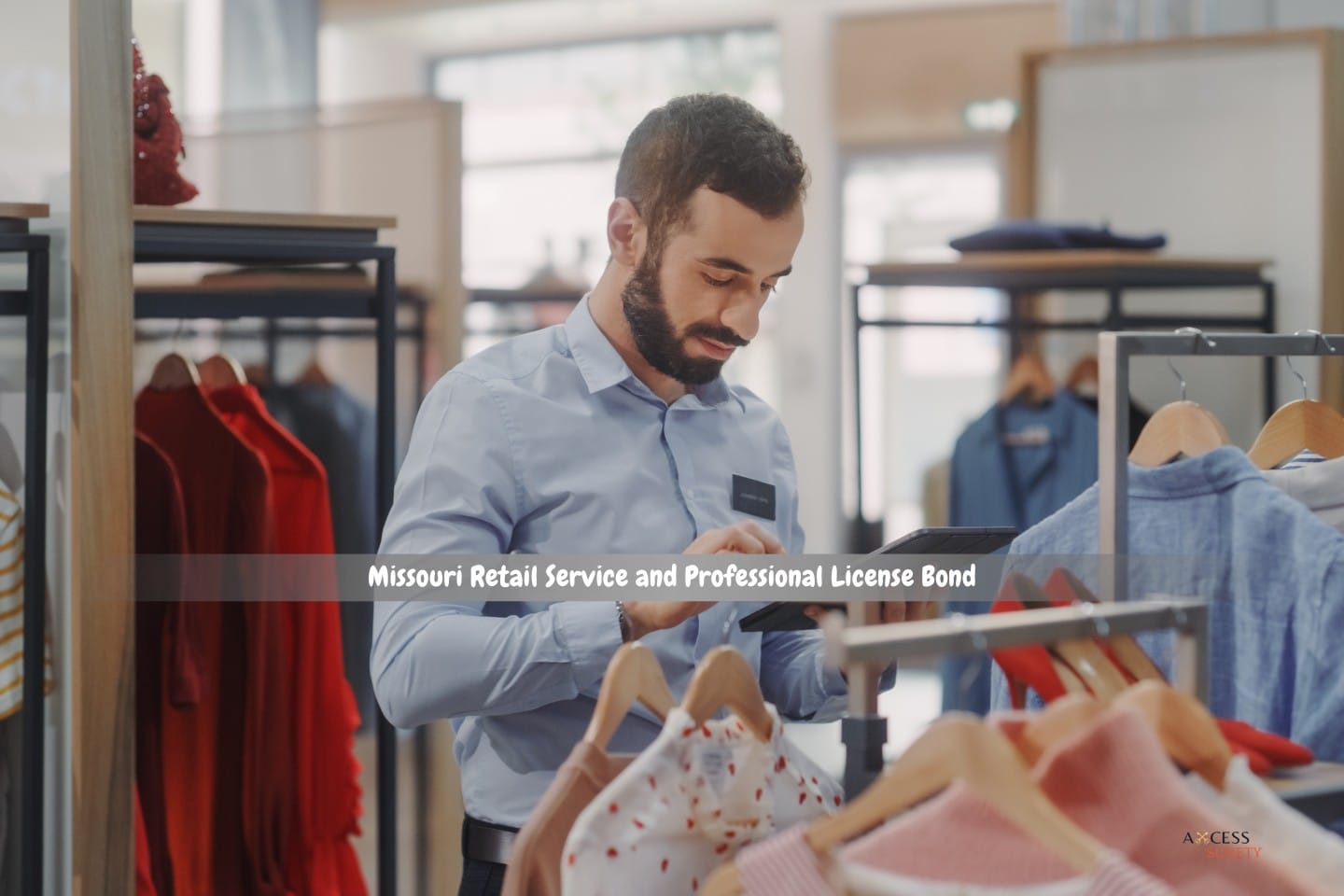 Missouri Retail Service and Professional License Bond - apparel retailer. A tablet computer is used by a male visual merchandising professional to develop collections.