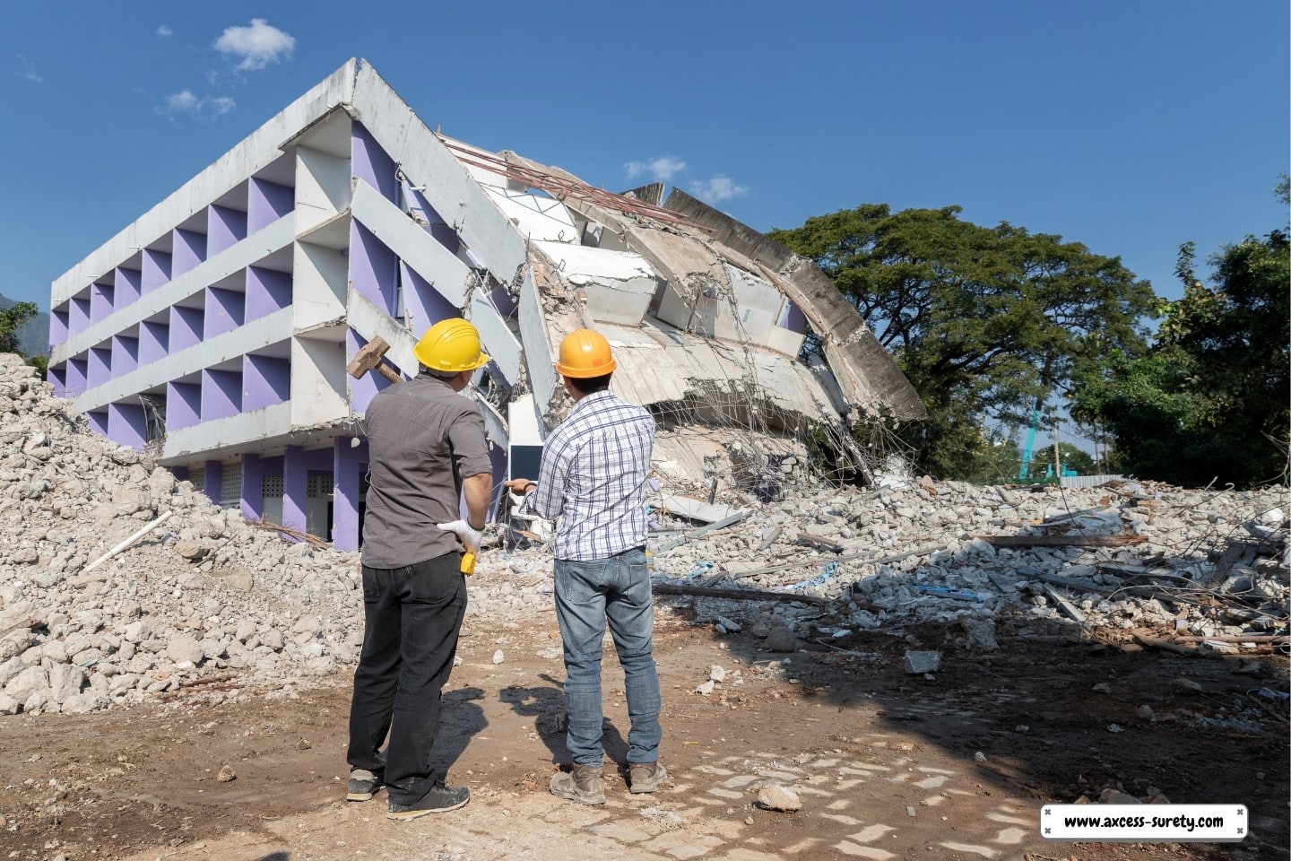 The contractor and the demolition control supervisor are talking about demolishing the structure.