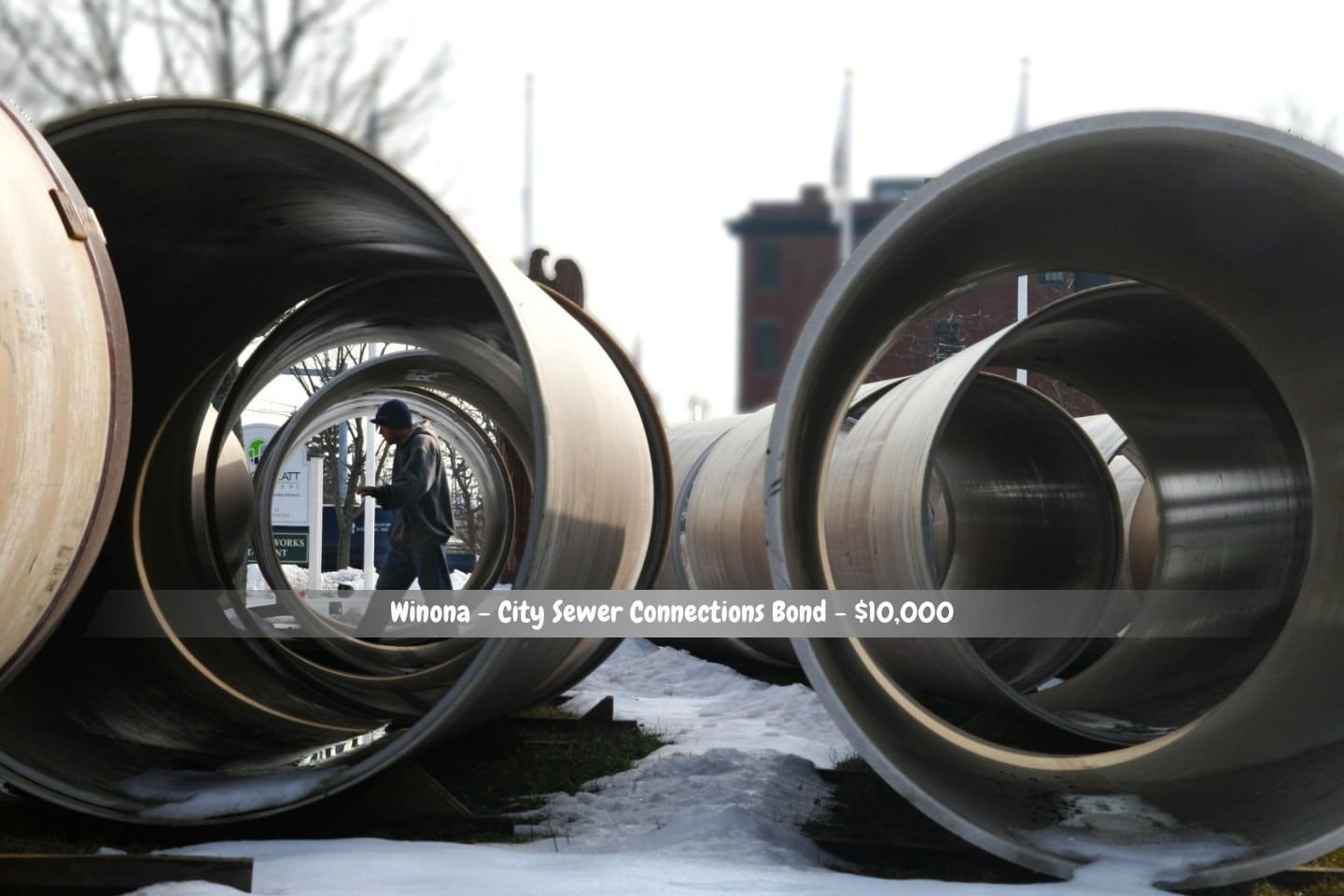 Winona - City Sewer Connections Bond - $10,000 - A stack of metal sewer hookup pipes.