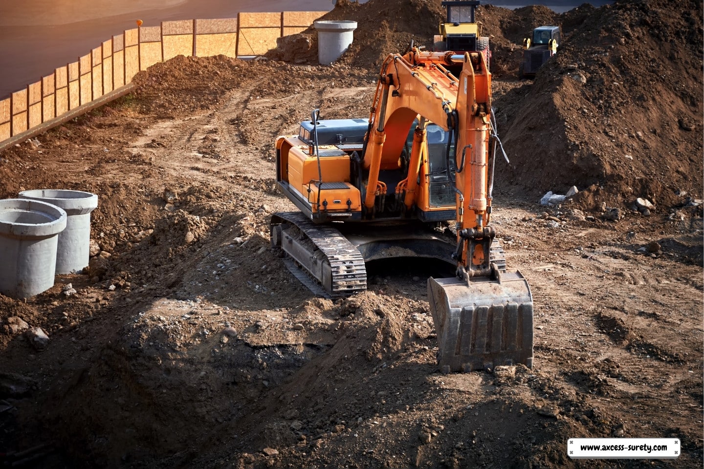 To replace sewer wells and pipes, a contemporary excavator excavates the earth.