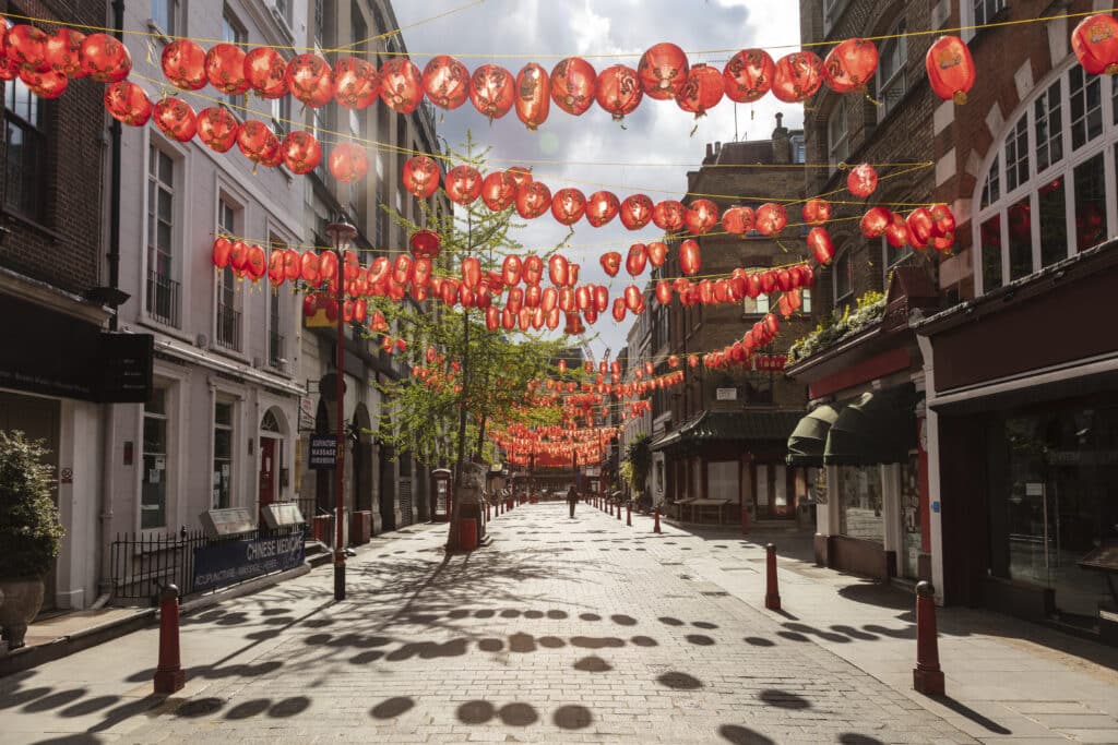 A festive street adorned with rows of red lanterns under a clear sky