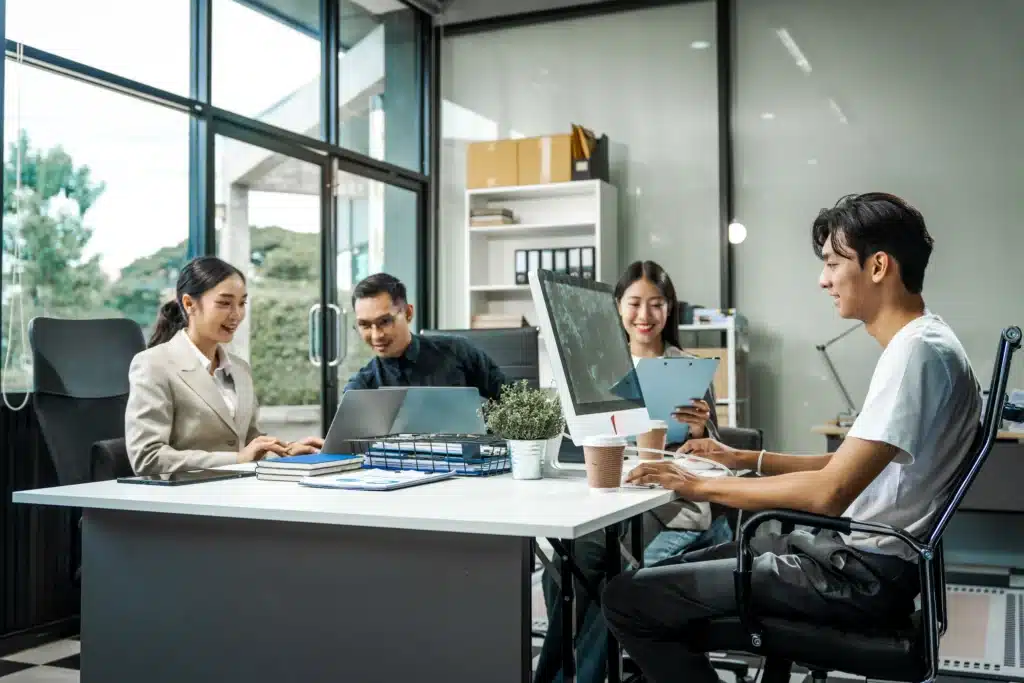 asian-colleagues-meet-at-a-desk-discussing-busine-2024-09-04-22-12-02-utc