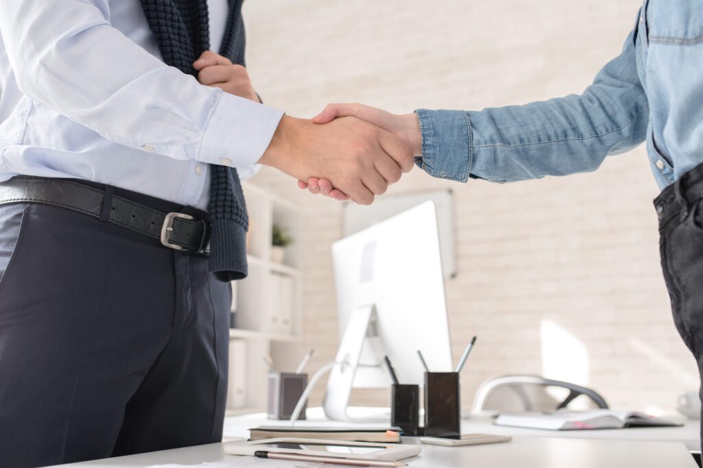 business-partners-shaking-hands-over-table-2023-11-27-05-30-13-utc_11zon