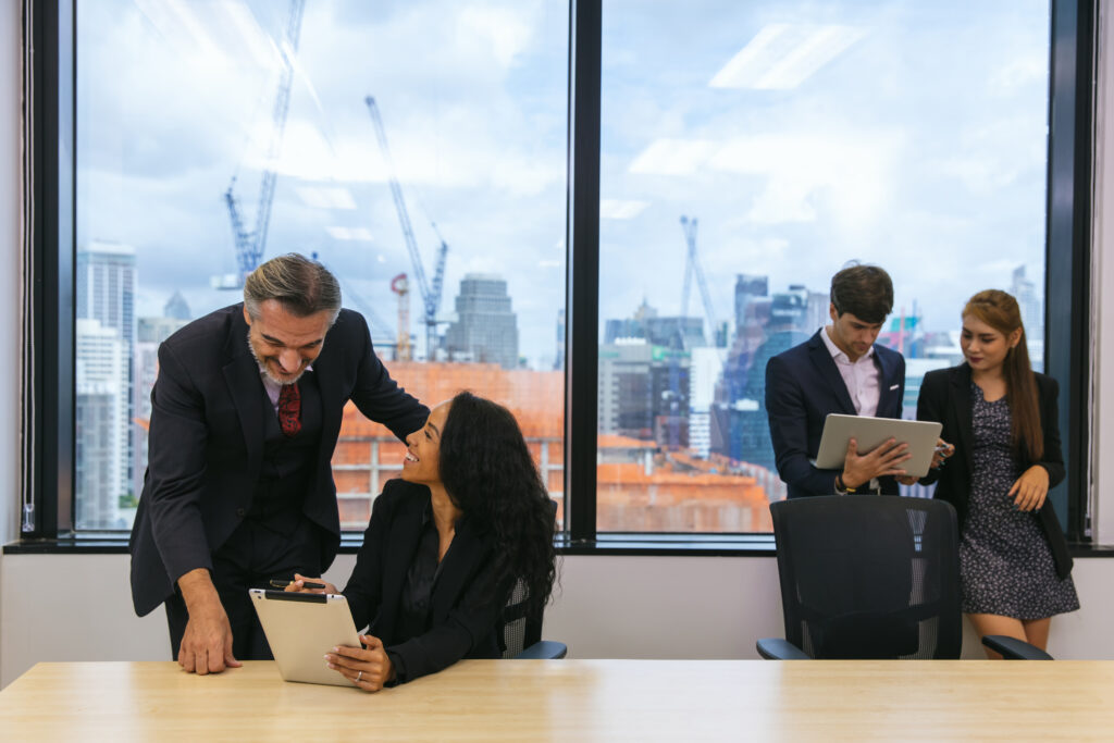 Businessman leader in marketing coaching interested business people, giving educational workshop presentation in modern office.