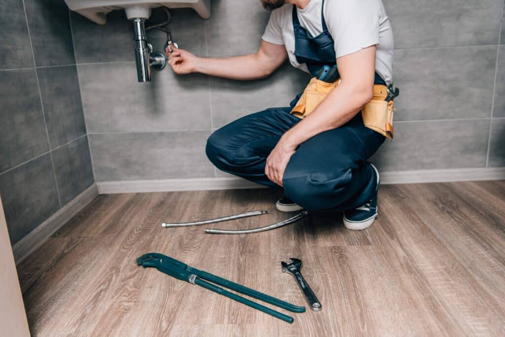 cropped-shot-of-male-plumber-with-toolbelt-repairi-2023-11-27-05-27-34-utc_11zon