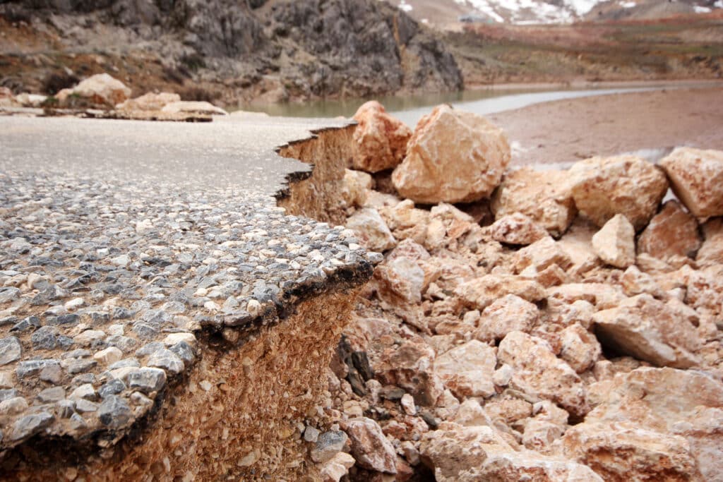 Damaged mountain asphalt road. Country road.
