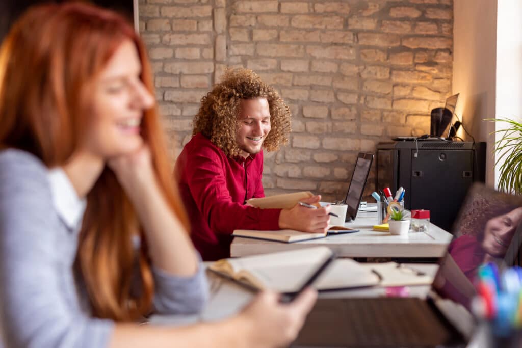 Young people working in a modern office; freelacers working in coworking space
