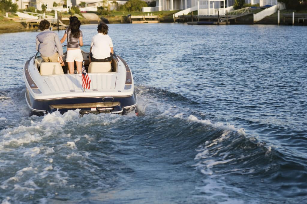 Friends enjoying a boat ride at dusk