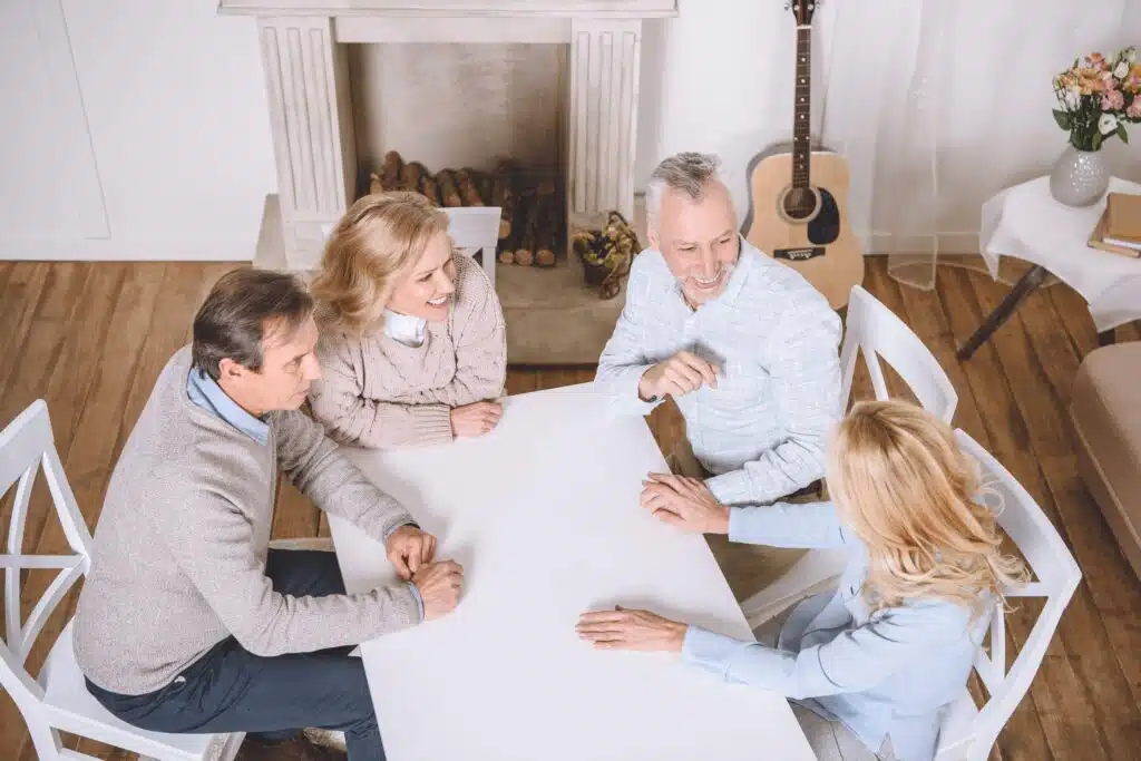 overhead-view-of-friends-sitting-at-table-and-spea-2024-11-01-04-09-12-utc_11zon