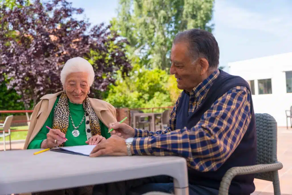two-elderly-people-painting-in-the-garden-of-a-nur-2023-11-27-05-26-50-utc_11zon
