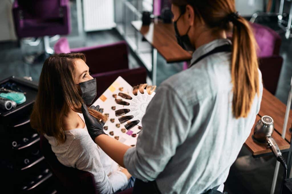 woman-with-face-mask-and-her-hairstylist-choosing-2023-11-27-05-27-29-utc_11zon