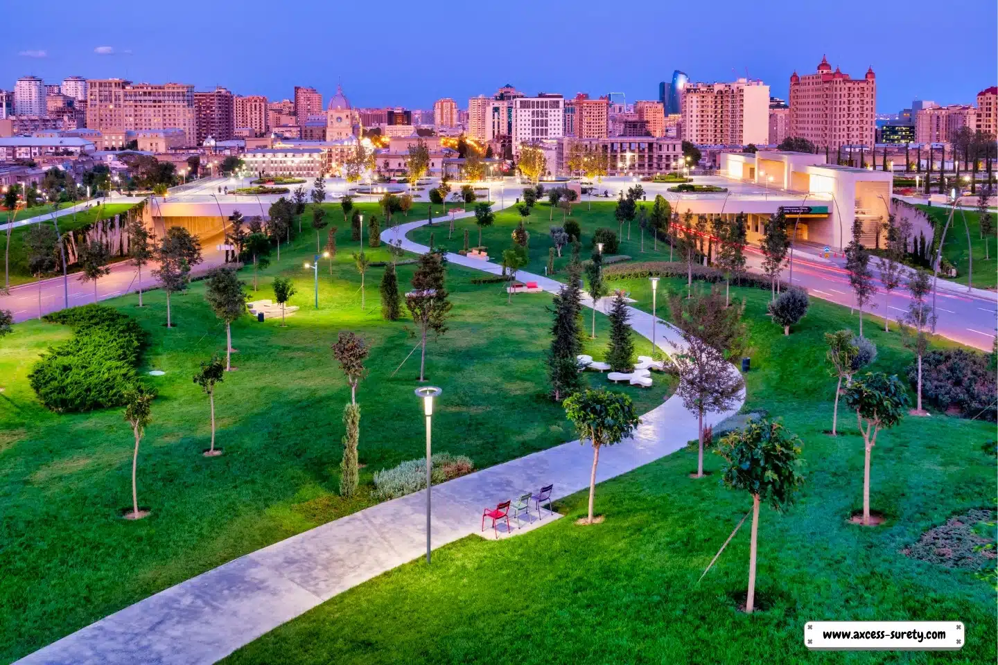 A park at the center of the downtown. Pathway, Trees and buildings.