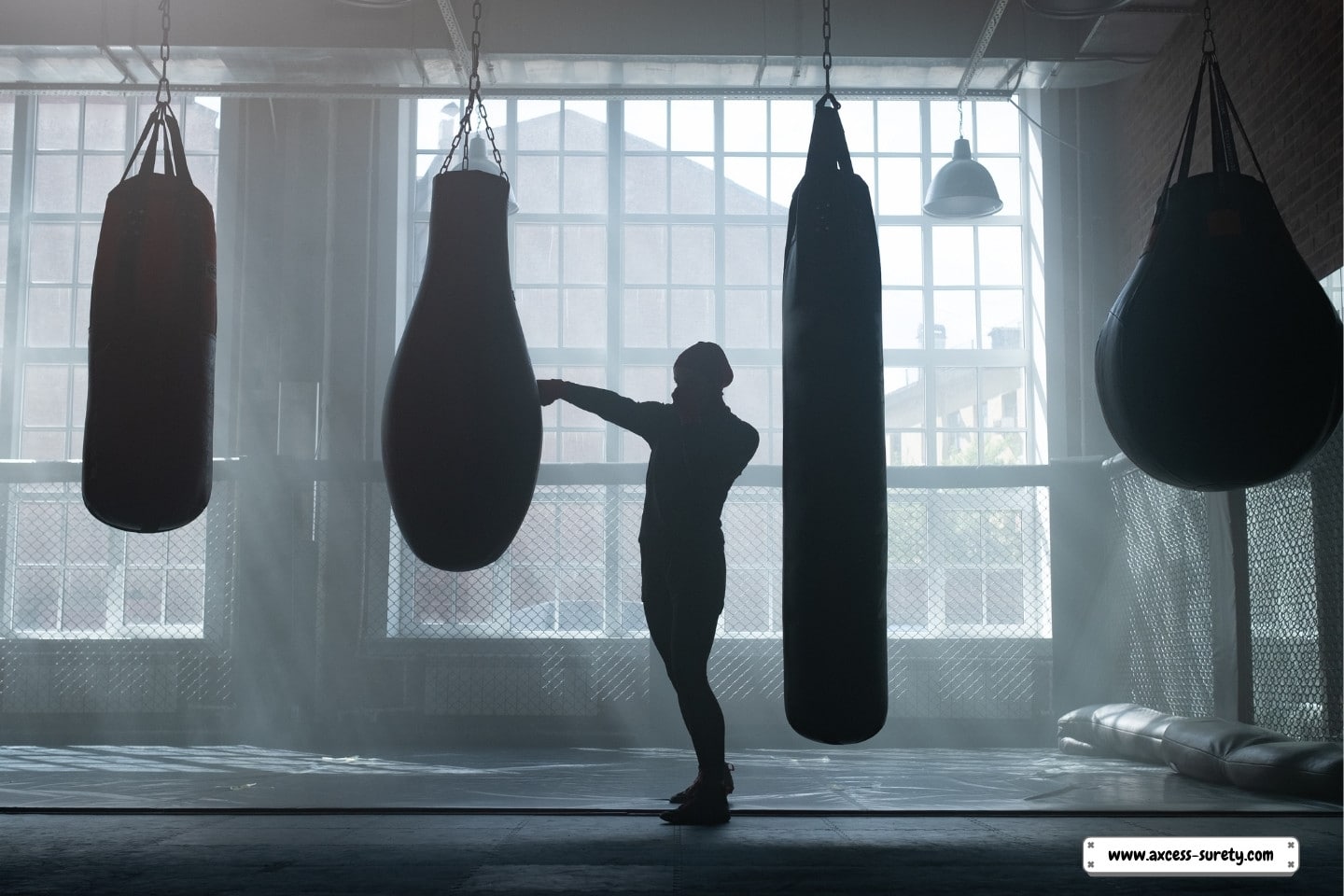 A person's silhouette in a boxing gym.