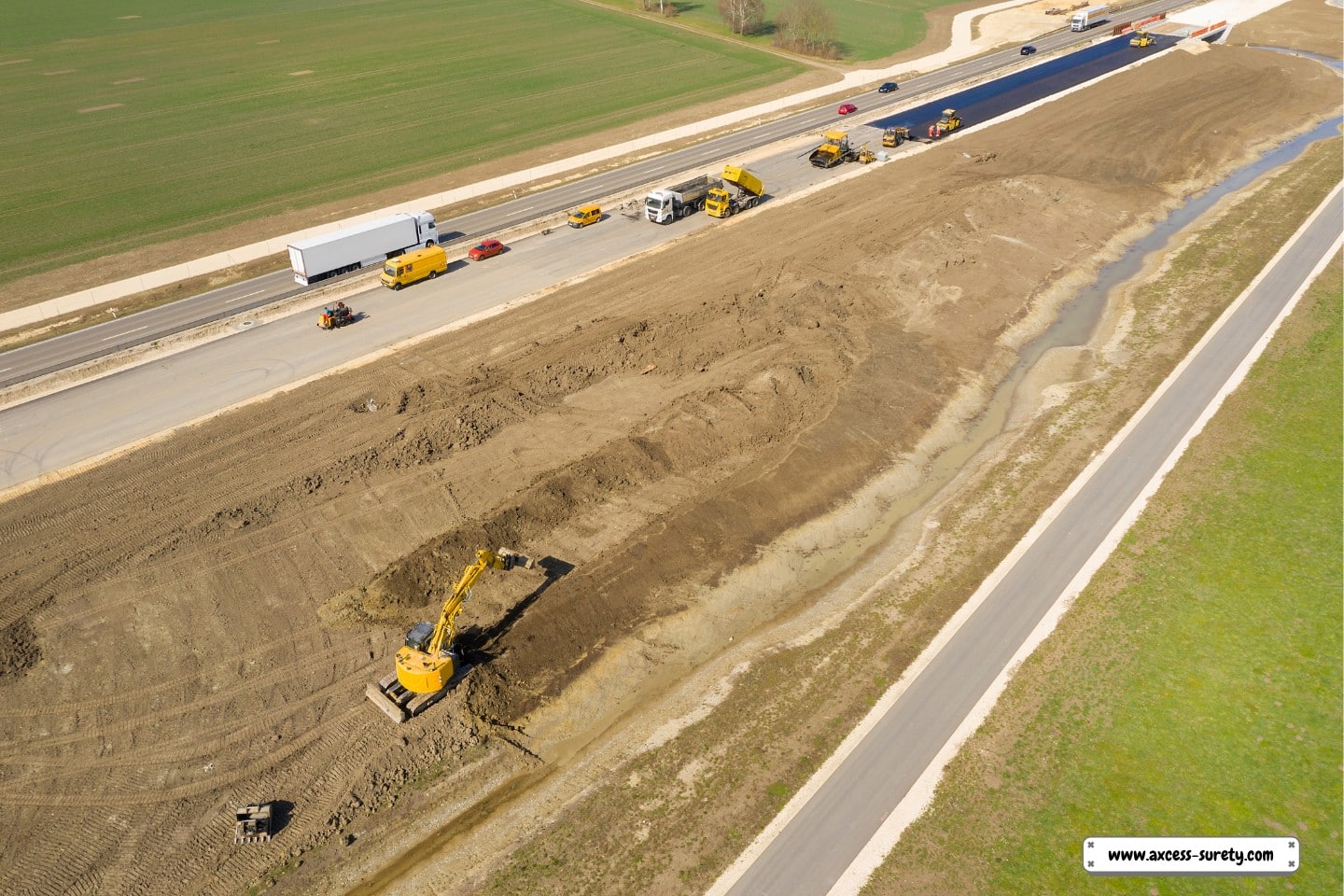construction of the highway.  When laying asphalt on a new road, a paver machine and other construction equipment and trucks are used.
