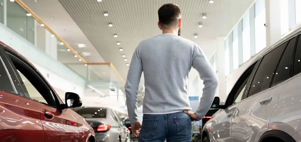 a-man-in-a-car-dealership-chooses-a-new-car-for-hi-2023-11-27-05-19-25-utc_11zon