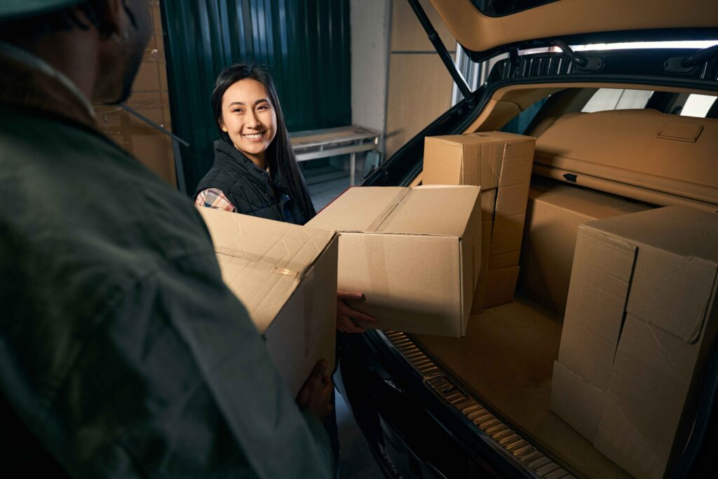 man-and-a-woman-unload-things-from-the-trunk-of-a-2024-05-30-20-30-40-utc_11zon