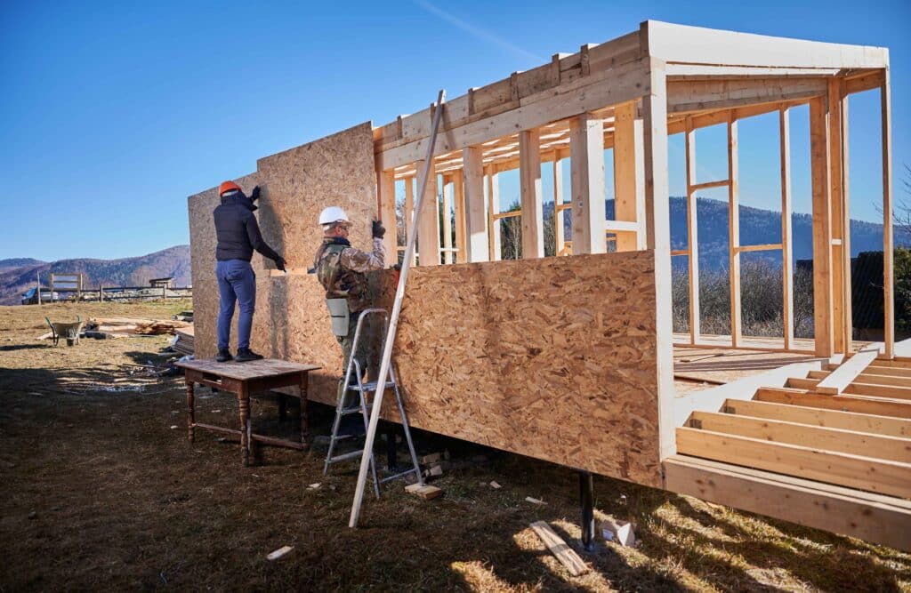 man-worker-building-wooden-frame-house-mounting-w-2023-11-27-04-53-41-utc_11zon