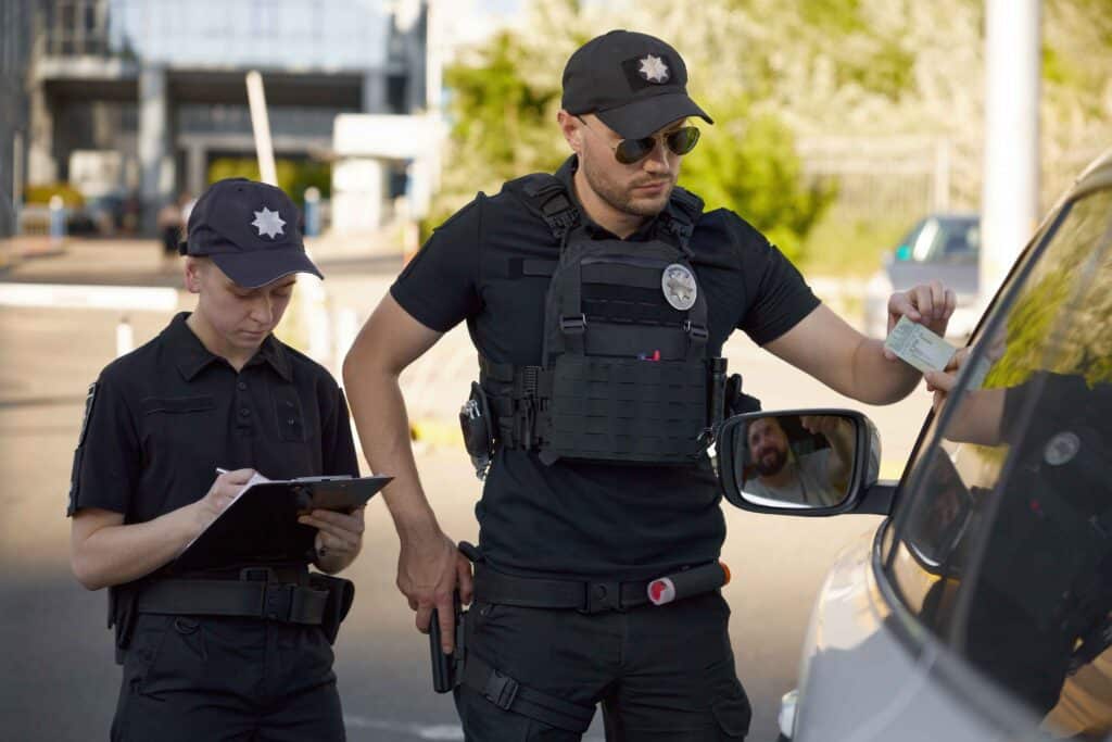 patrolman-and-patrolwoman-team-writing-traffic-tic-2024-10-14-23-25-53-utc_11zon