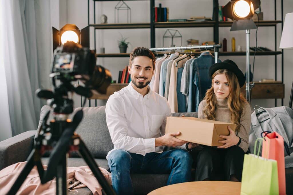 smiling-fashion-bloggers-sitting-with-box-in-front-2024-11-01-04-17-04-utc_11zon