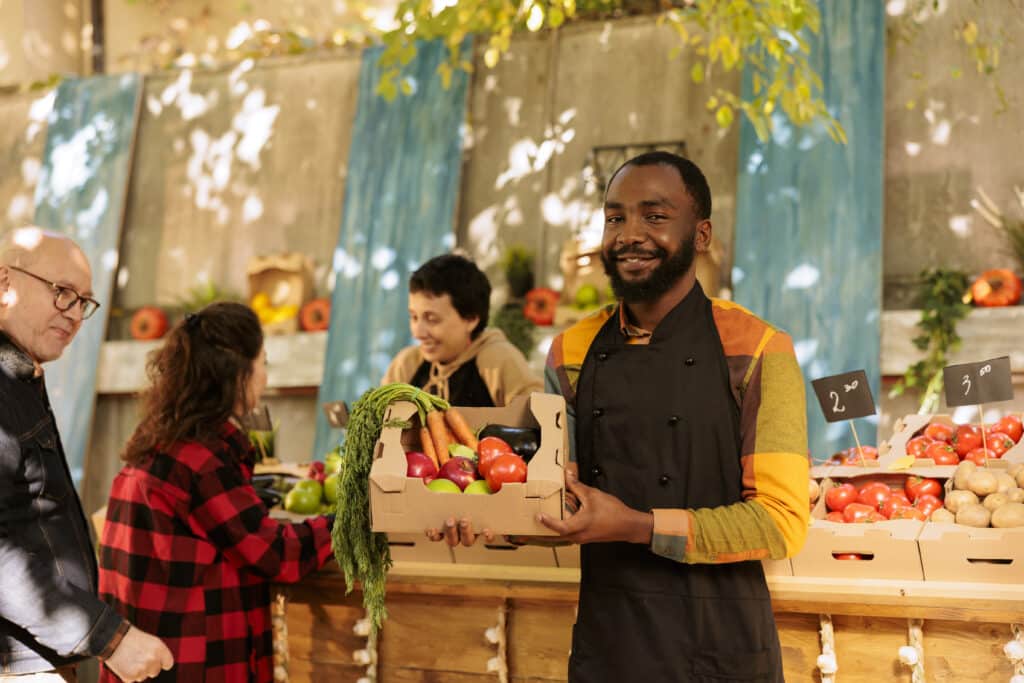 Vendor with apron posing at local market