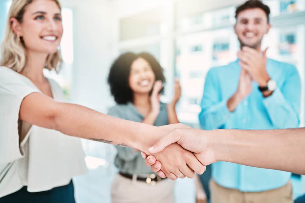 Business people, handshake and clapping for b2b partnership in success, vision and growth at the of.