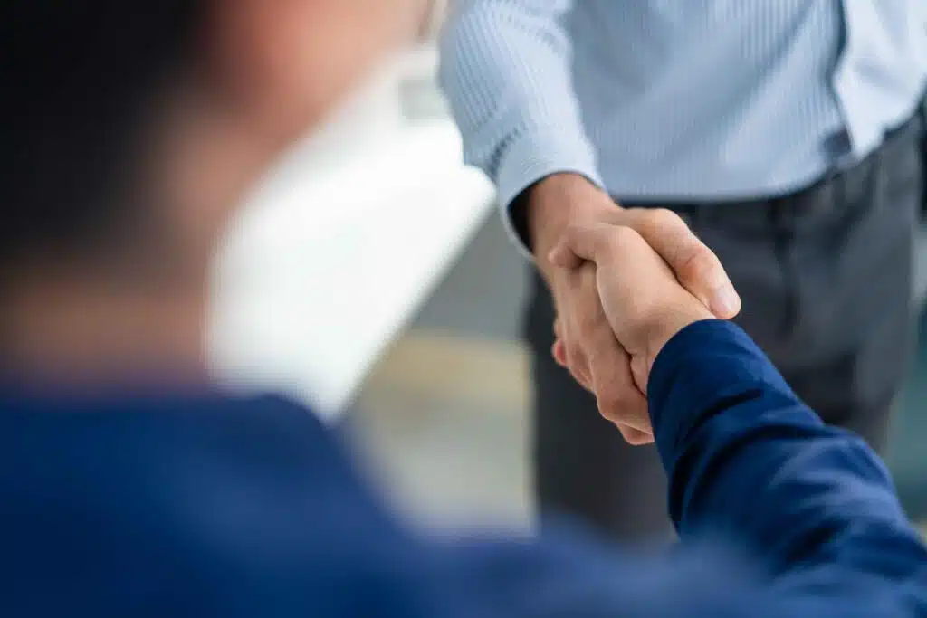 close-up-of-businessman-making-handshake-while-sta-2024-08-09-15-30-32-utc_11zon
