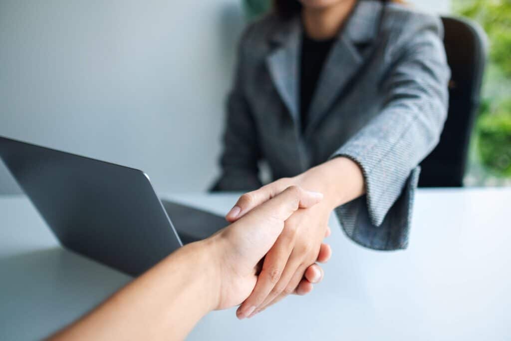 closeup-image-of-two-businesspeople-shaking-hands-2023-11-27-05-23-02-utc_11zon