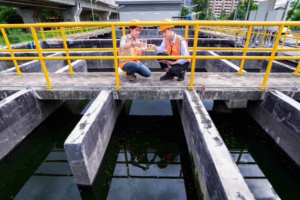engineer-take-water-from-wastewater-treatment-pond-2023-11-27-05-18-03-utc_11zon