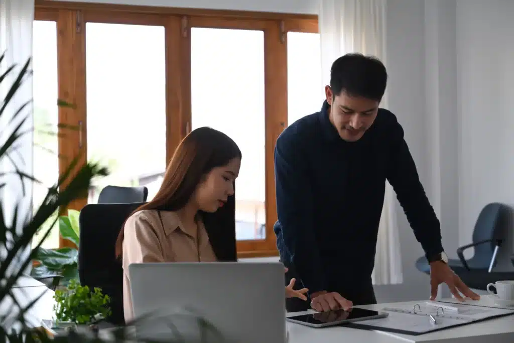 friendly-young-asian-manager-explaining-reasons-an-2023-11-27-05-00-16-utc