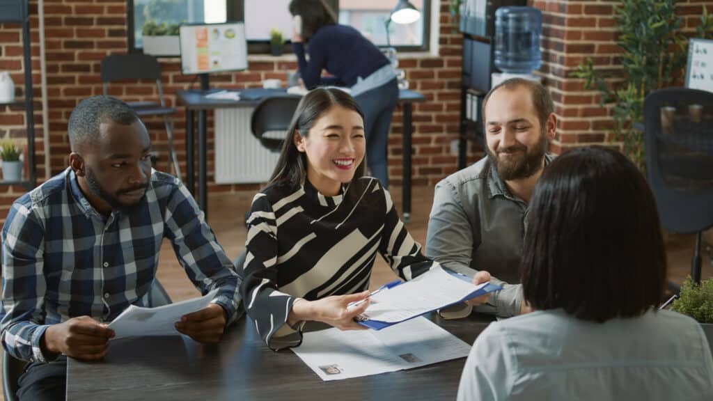 HR workers hiring woman and making employment deal, signing work contract after successful job interview. Female applicant getting hired at business company, joining executive team.