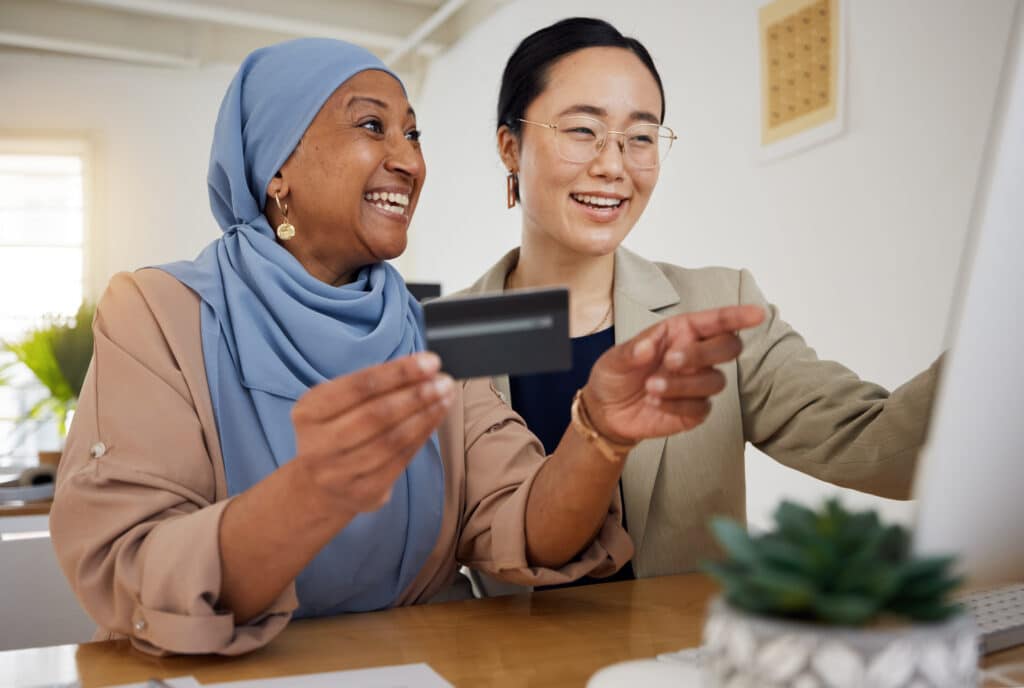 Online shopping, credit card and woman at customer service desk for banking and talking to a consul.