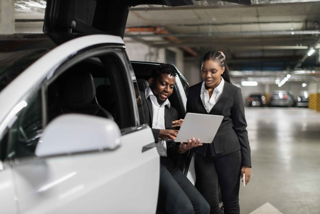 coworkers-discussing-issues-via-laptop-in-ev-in-ba-2024-12-13-08-31-51-utc_11zon