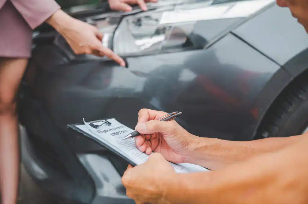 male insurance officer came to help inspect a customer's car that had an accident. Concept for vehicle crash, insurance claim.