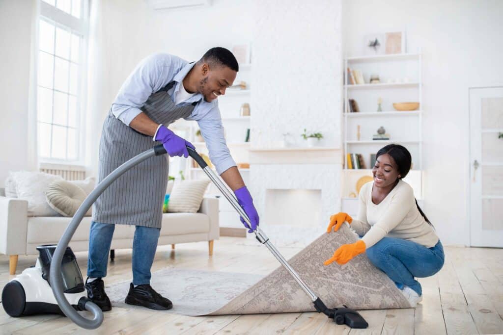 positive-black-couple-cleaning-up-together-vacuum-2023-11-27-05-20-27-utc_11zon